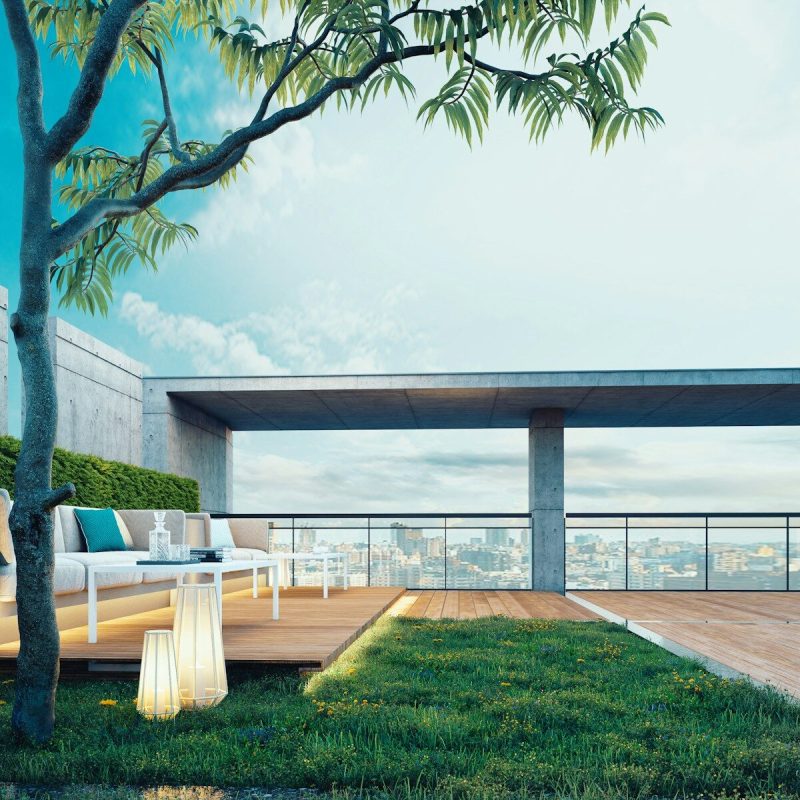 Modern rooftop patio with city view and lounge seating.